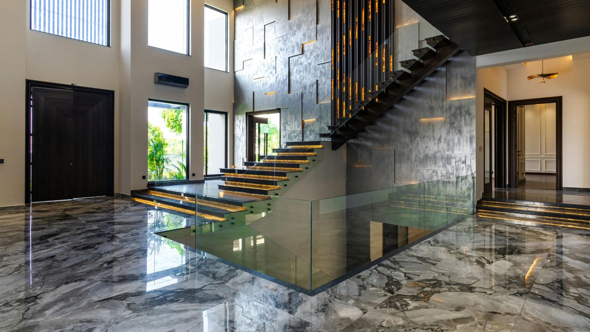 Modern interior with floating glass staircase and marble floor